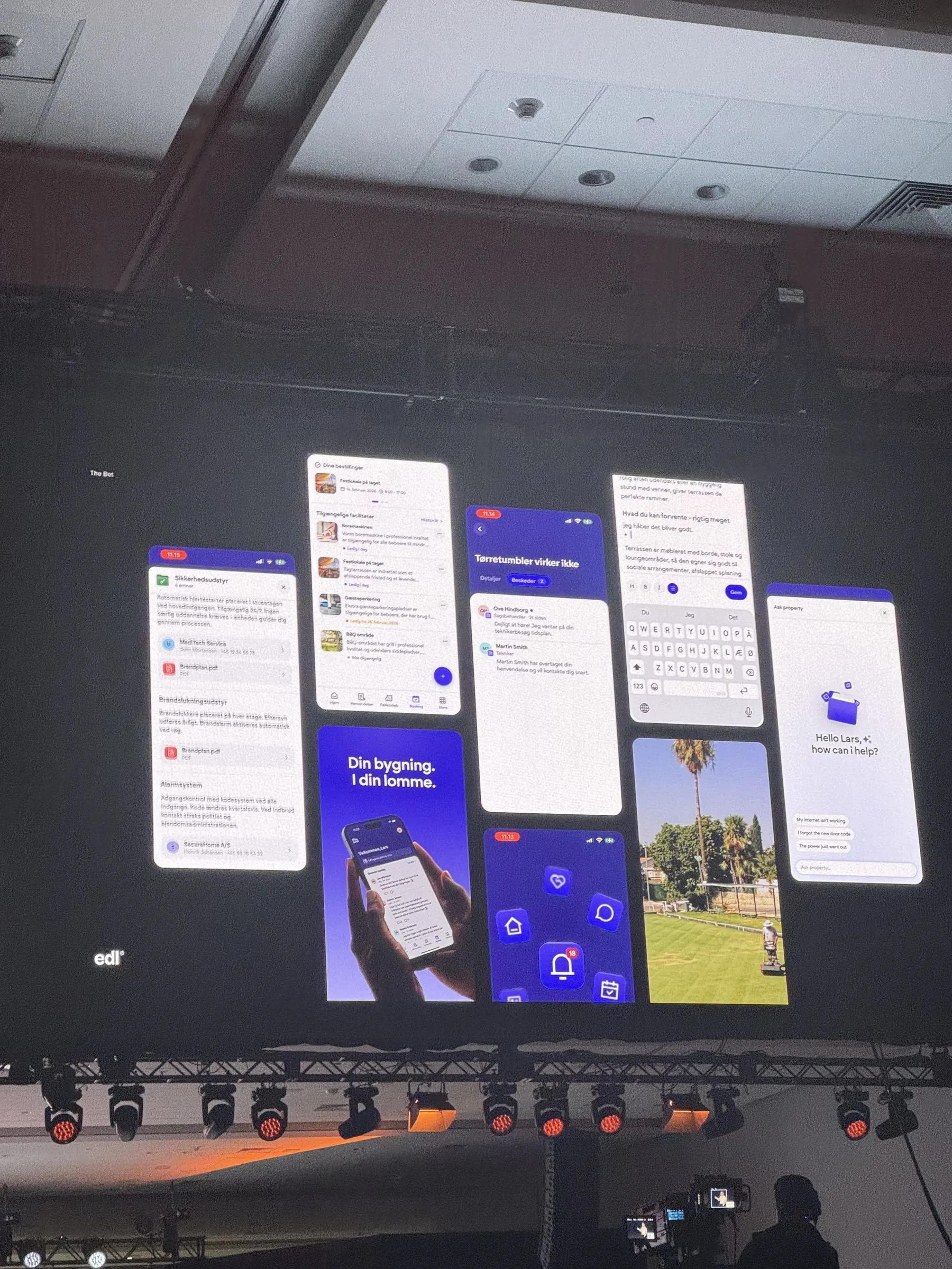A wall of indigo and white mobile app screens from a client project, shown on the main stage under the studio's mark