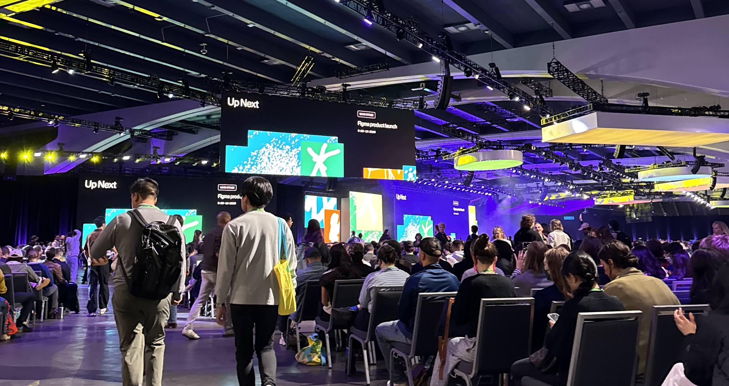 The Config main hall, with 'Up Next—Figma product launch' on the screens above a seated crowd